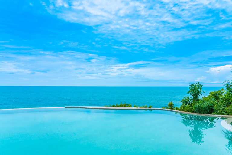 Beautiful outdoor infinity swimming pool in hotel resort with se